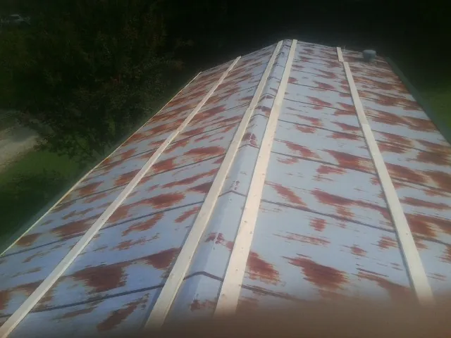 Rusted metal roof panels with new wood purlins before replacement — Storm Damage Roof Repair in Fort Payne by Roofing Brothers
